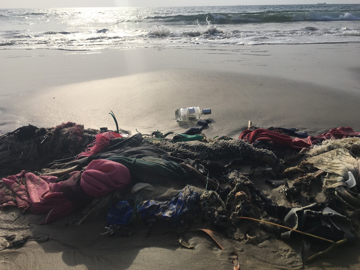 Image of rubbish on the shore to provide an atmospheric portrayal of grief, through this sad image